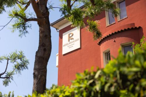 a red brick building with a sign on it at Hotel Royalmar - Nouveau propriétaire in Cagnes-sur-Mer