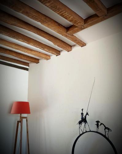 a room with a wall with a statue of a man fishing at L'Ecrin des Marronniers in Abondant