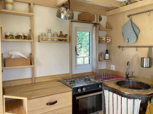 a small kitchen with a sink and a stove at La Tiny de Margny in Margny-lès-Compiègne
