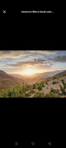 a picture of a desert with the sun setting in the horizon at Morocco Tour Itineraries in Merzouga