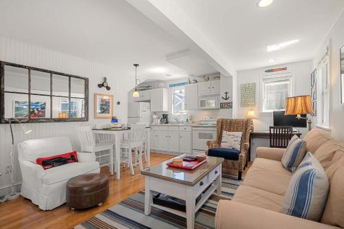 a living room with a couch and a table at Private Deck Parking Walk to Town in Provincetown