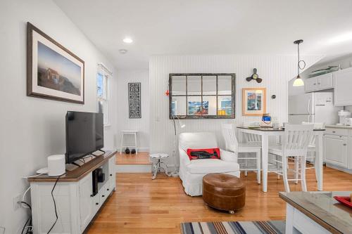 a living room with a kitchen and a dining room at Private Deck Parking Walk to Town in Provincetown