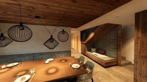 a dining room with a wooden table and a fireplace at Almhütte Auszeit - Neueröffnung Dezember 2025 in Saalbach Hinterglemm