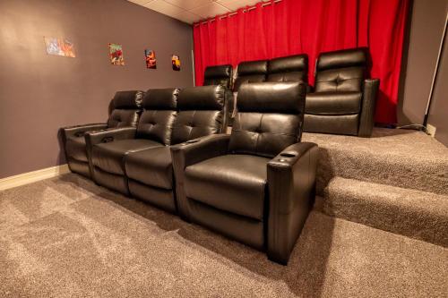 two leather reclining chairs in a room with red curtains at Smoky Mountain Excellence By Avada Properties in Kodak