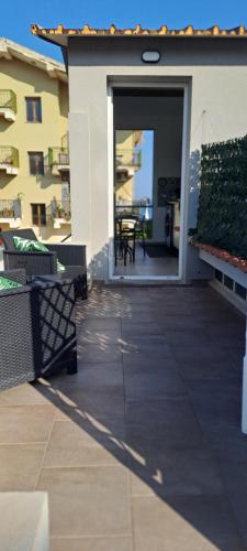 a patio with benches and a door to a building at MonoMare in Avola