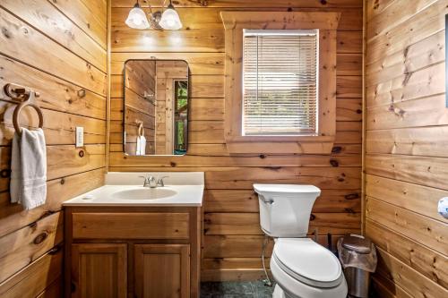 a bathroom with a toilet and a sink at Mountain Dream By Avada Properties in Sevierville