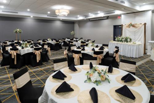 a room with tables and chairs with hats on them at Holiday Inn Rock Hill by IHG in Rock Hill