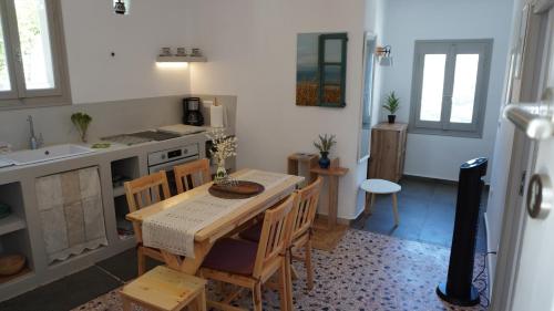 a kitchen with a table and chairs in a room at Lagadi House 2 in Arnados