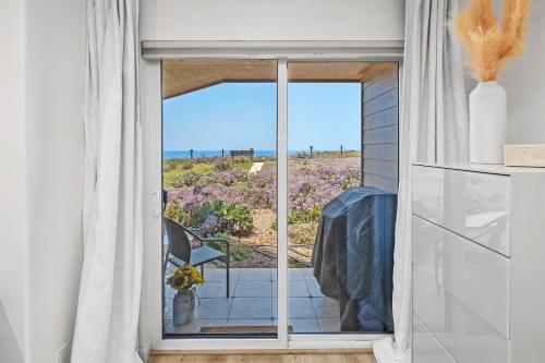 a room with a window with a view of the ocean at Surf Song Symphony - SONG55 in Solana Beach