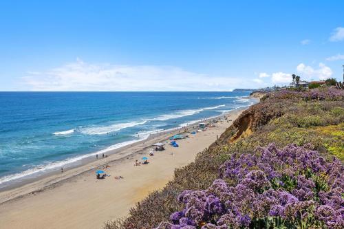 a beach with a bunch of people and the ocean at Surf Song Symphony - SONG55 in Solana Beach