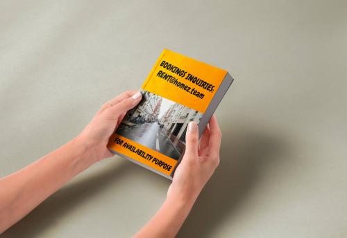 une personne tenant un livre entre ses mains dans l'établissement One bedroom apartment with its modern decor - CheckProfile, à Levallois-Perret