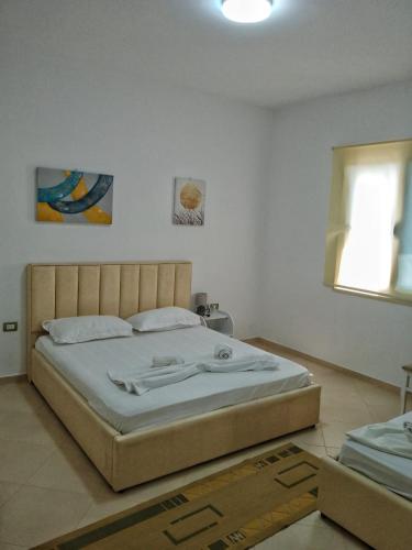 a bedroom with a large bed in a room at Villa Agim,Hena in Vlorë