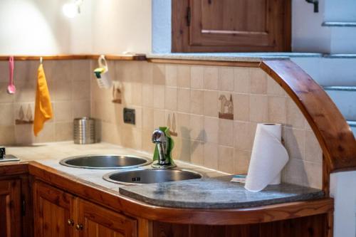 a kitchen with a sink and a counter top at Comodità a due passi dal lago in Verbania