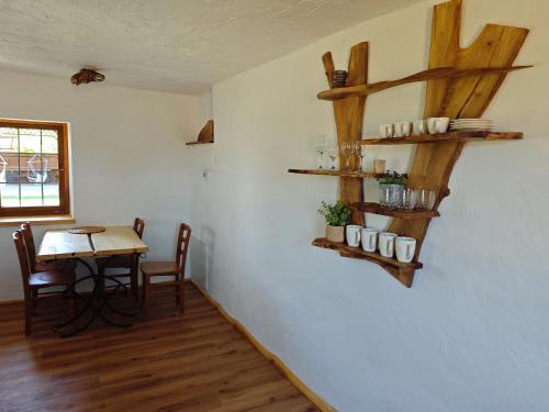 a dining room with a table and a table and chairs at RANČ JUREŠ in Ljutomer