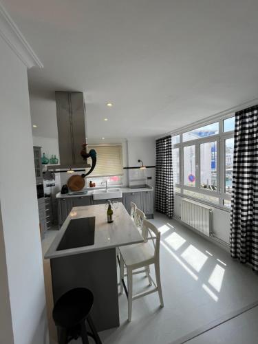 a kitchen with a sink and a table and chairs at La Rula in Luarca