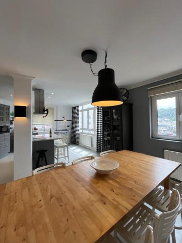 a kitchen and dining room with a wooden table and chairs at La Rula in Luarca