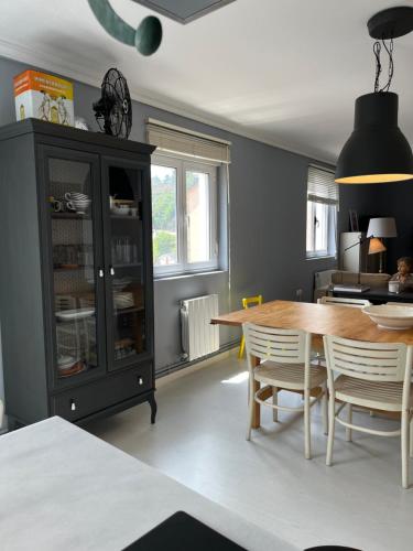 a dining room with a table and a cabinet at La Rula in Luarca