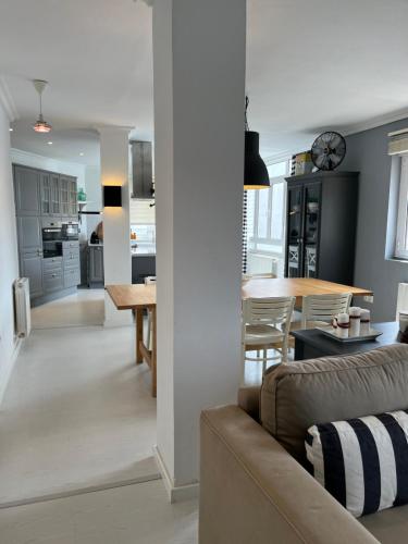 a living room and kitchen with a couch and a table at La Rula in Luarca