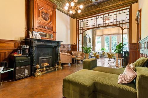 a living room with a fireplace and a couch at B&B Baron Osy Suite Four Garden in Antwerp