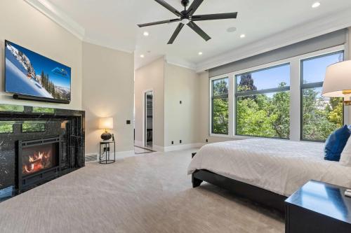 a bedroom with a fireplace and a bed and a tv at Majesty Estate in Salt Lake with Private Pool and Sport Court in Draper