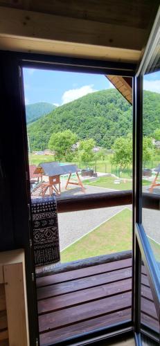 a view of a picnic table from a window at Котеджі Карпати Fest in Mizhhirʼʼya