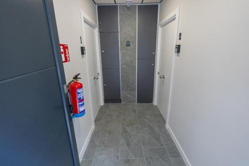 a hallway with a fire extinguisher in a bathroom at Bilbao Loft Apartments in Bilbao