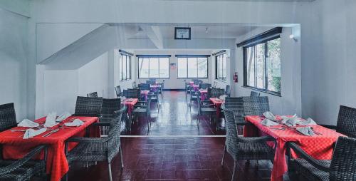 a dining room with red tables and chairs at Milele Beach Hotel in Bamburi