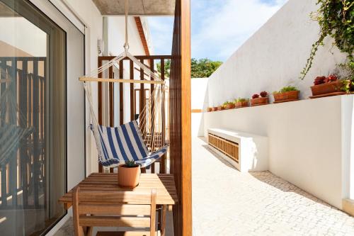a patio with a chair and a table on a balcony at Santa Cruz Dive House - PADI Centre in Santa Cruz