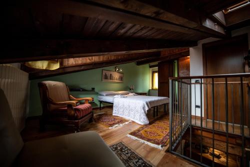 a bedroom with a bed and a chair at Comodità a due passi dal lago in Verbania