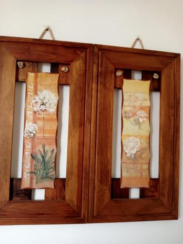two wooden frames with ties on a wall at Anguiano Habitaciones rurales con baño privado in Anguiano