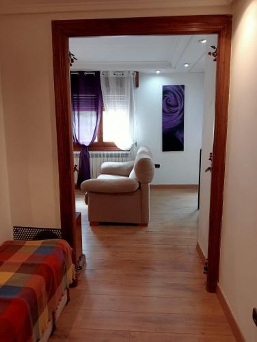 a living room with a couch and a chair at Anguiano Habitaciones rurales con baño privado in Anguiano