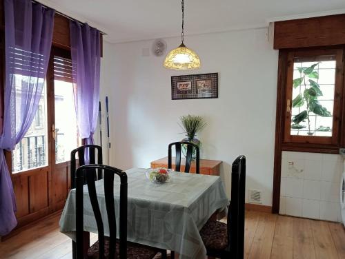 a dining room with a table and two chairs at Anguiano Habitaciones rurales con baño privado in Anguiano