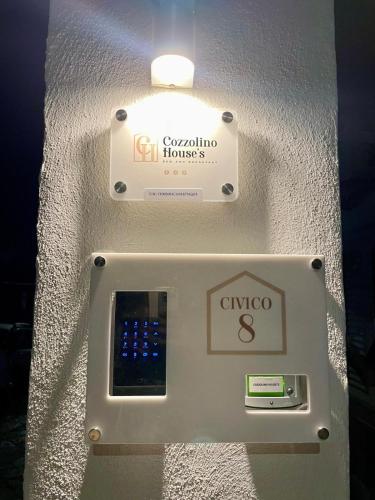 a cell phone in a wall with a light at B&B Cozzolino House's in Ercolano