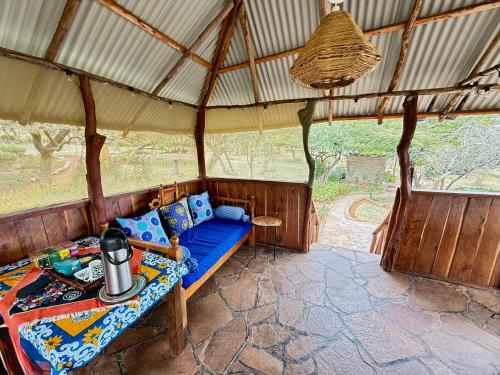 a room with a couch in a tent at Authentic Mara Bush Home in Sekenani