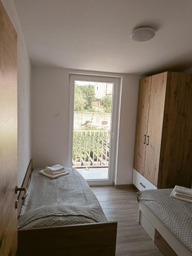 Postel nebo postele na pokoji v ubytování Apartman BARONI