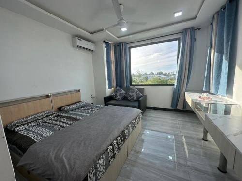 a bedroom with a large bed and a large window at Quest by Entrance in Feydhoo