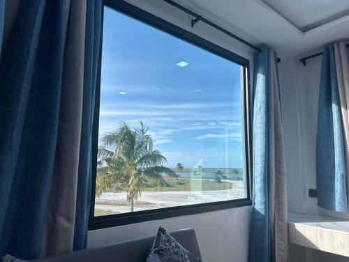 a window in a room with a view of a beach at Quest by Entrance in Feydhoo