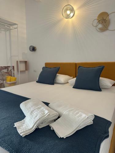 a bedroom with two white pillows on a bed at La MAISON D'ISABELLE in Bari