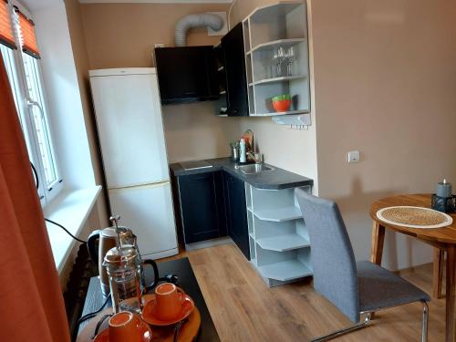 a small kitchen with a sink and a table at Kesklinna korter in Kuressaare