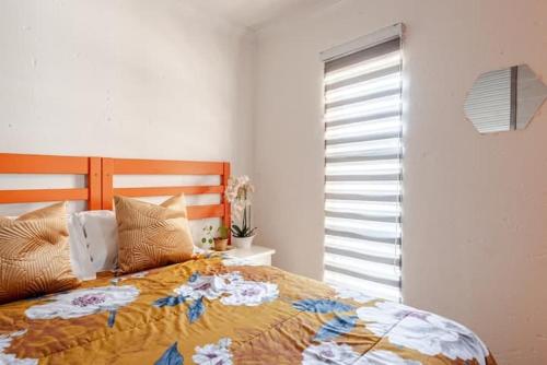 a bedroom with a bed and a window at Monoshez in Benoni