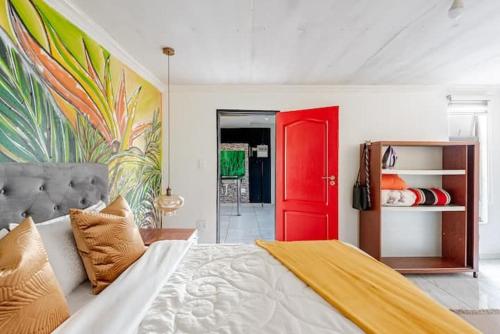a bedroom with a bed with a red door at Monoshez in Benoni