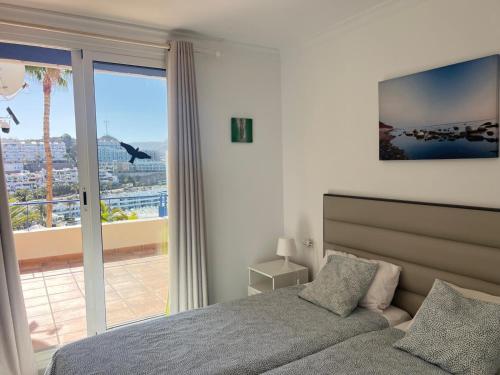 a bedroom with a bed and a large window at Toni LuXx Suite Monte Golf in Mogán