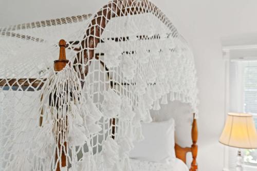 a bedroom with a white canopy bed with a giraffe net at Stunning Cottage in Famous KY Garden -Sleeps 2 in Prospect