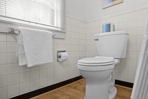 a bathroom with a toilet with a roll of toilet paper at Stunning Cottage in Famous KY Garden -Sleeps 2 in Prospect