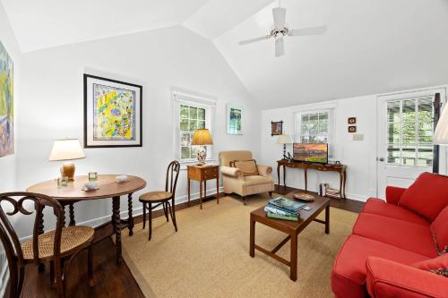 a living room with a red couch and a table at Stunning Cottage in Famous KY Garden -Sleeps 2 in Prospect