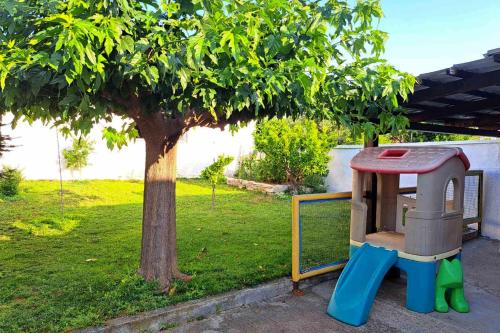 a toy dog house sitting next to a tree at Village Stone House in Ofrínion