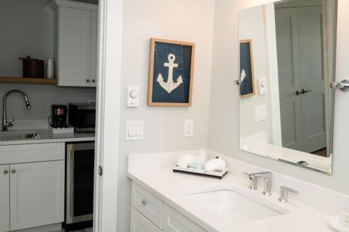 a white bathroom with a sink and a mirror at Terrace By The Sea in Ogunquit