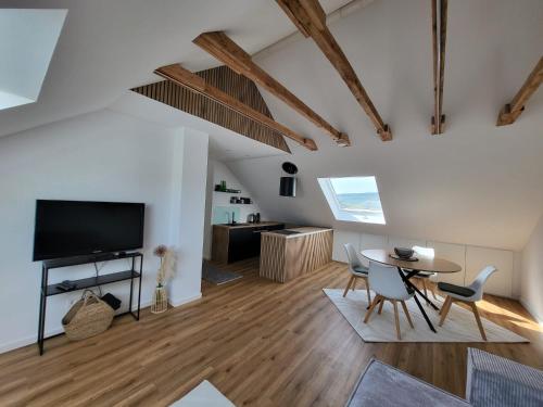 a living room with a tv and a table and chairs at Moselluft2 in Leiwen