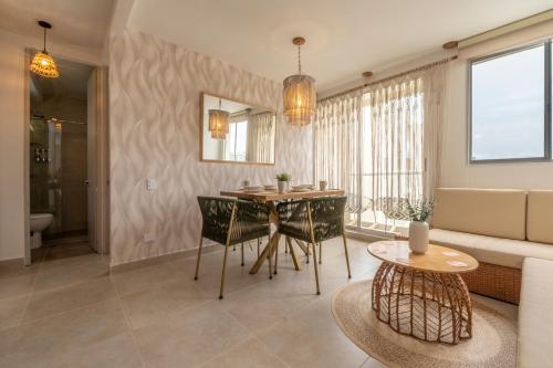 a living room with a table and a couch at Apartment with a Pool and Parking 2Bed in Cartagen in Cartagena de Indias