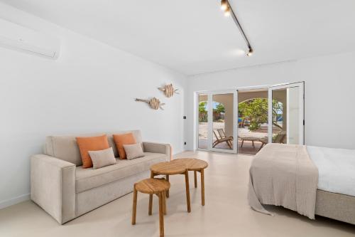 a white bedroom with a bed and a couch at Sorobon Bay Hotel in Kralendijk
